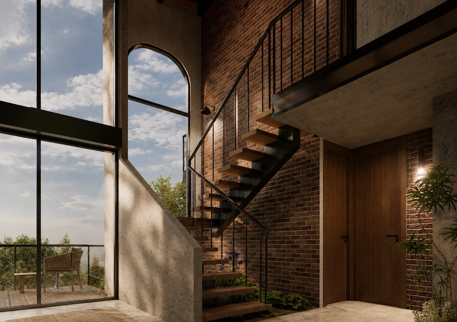 Escalera interior junto a muro de ladrillo, arco acristalado y ventanales de doble altura